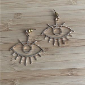 Gold eye earrings